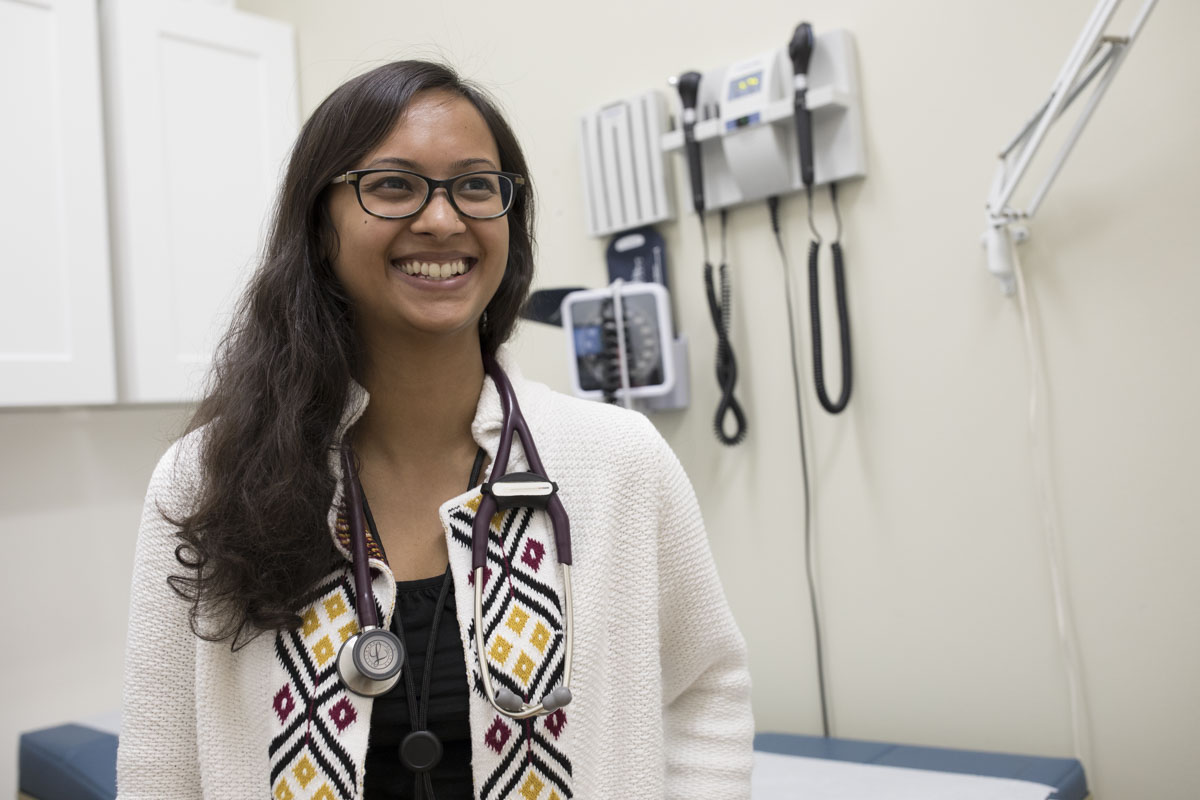 Person with a stethoscope in an examination room